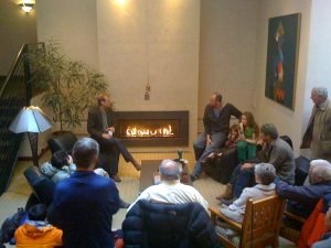 Conrad and David hold court in front of a roaring fire